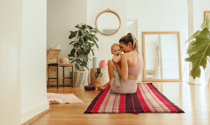 Foldout roll-out mattress with red and dark striped cover, flat open surface