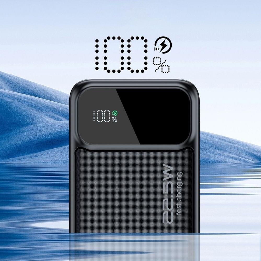 Black power bank with digital display showing 100% charge, textured front panel