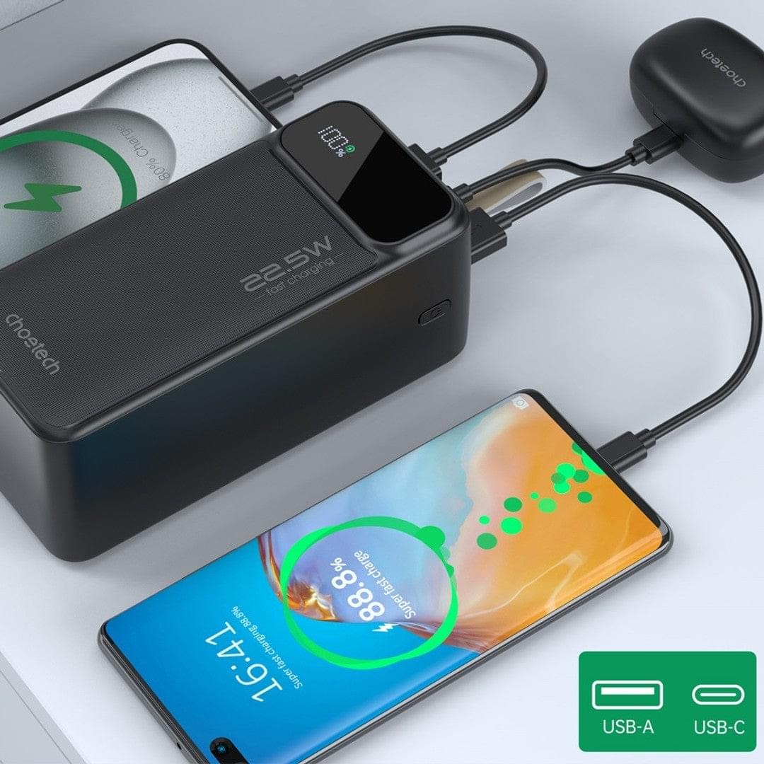 Black 22.5W power bank charging smartphones with USB cables, digital display visible