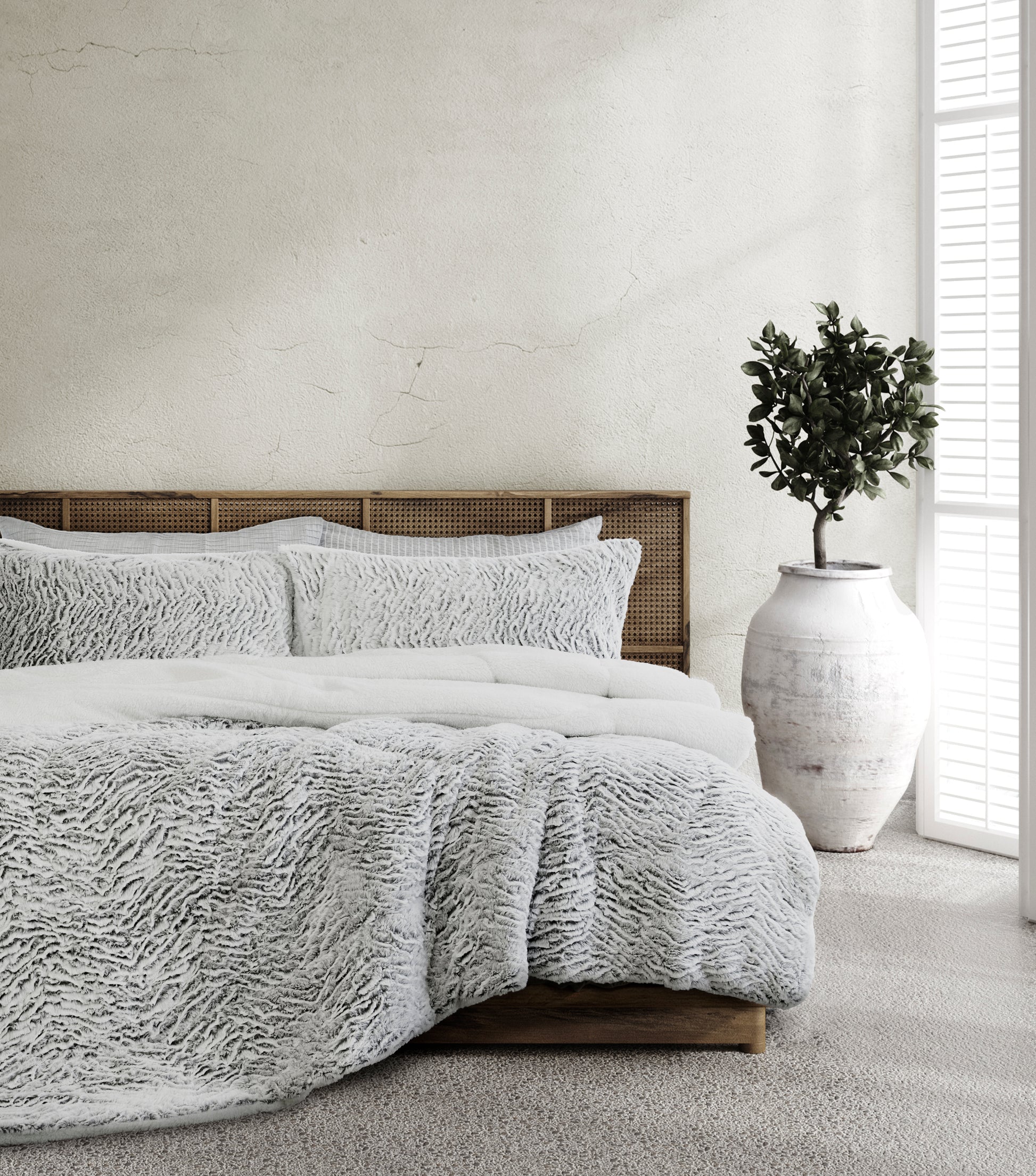 3-piece faux fur sherpa comforter set on bed with matching shams, light gray
