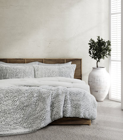 3-piece faux fur sherpa comforter set on bed with matching shams, light gray