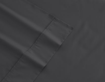 Dark gray fitted sheet corner with double-stitched hem and seam detail