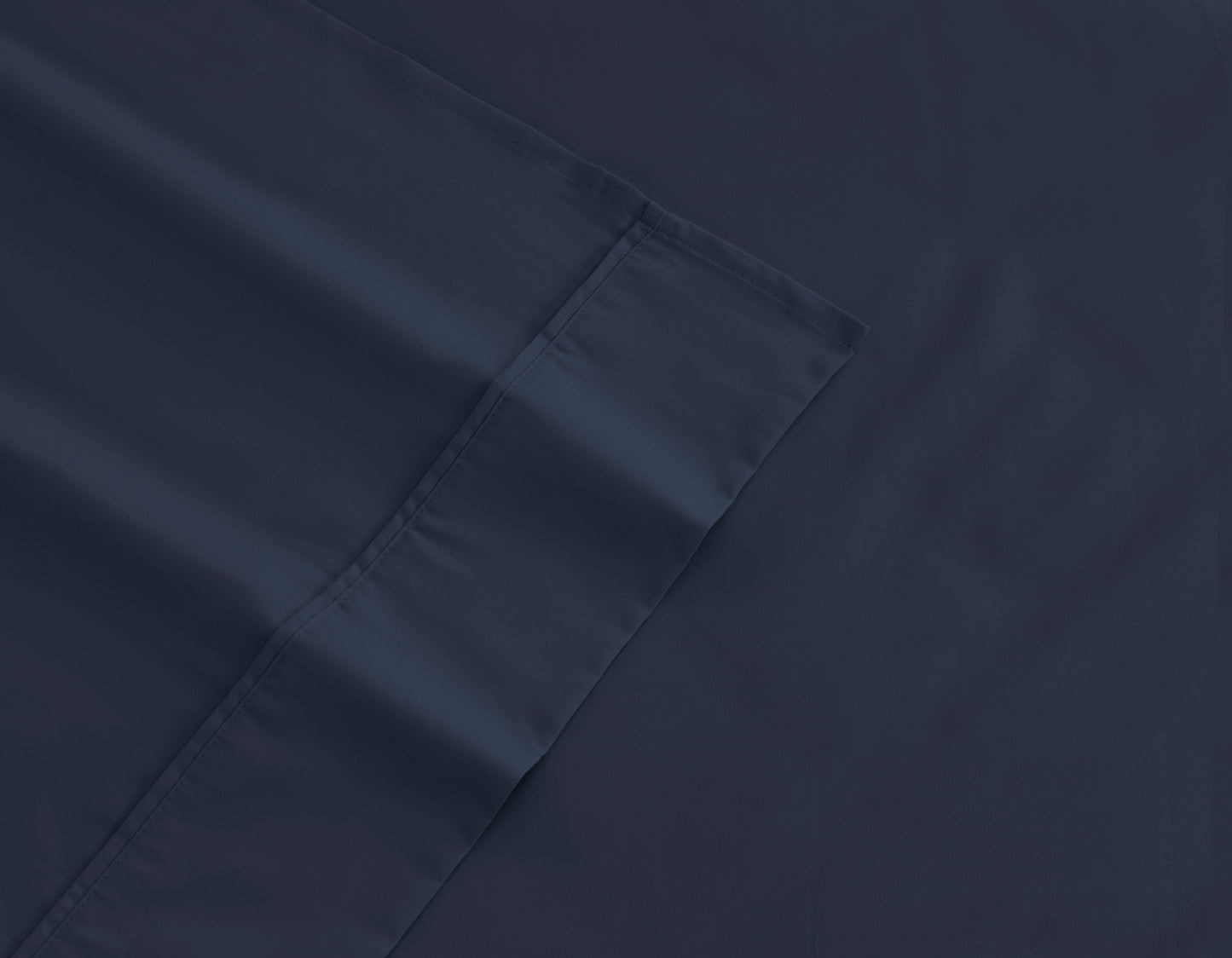 Navy cotton sheet fabric close-up with stitched seam