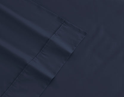 Navy cotton sheet fabric close-up with stitched seam
