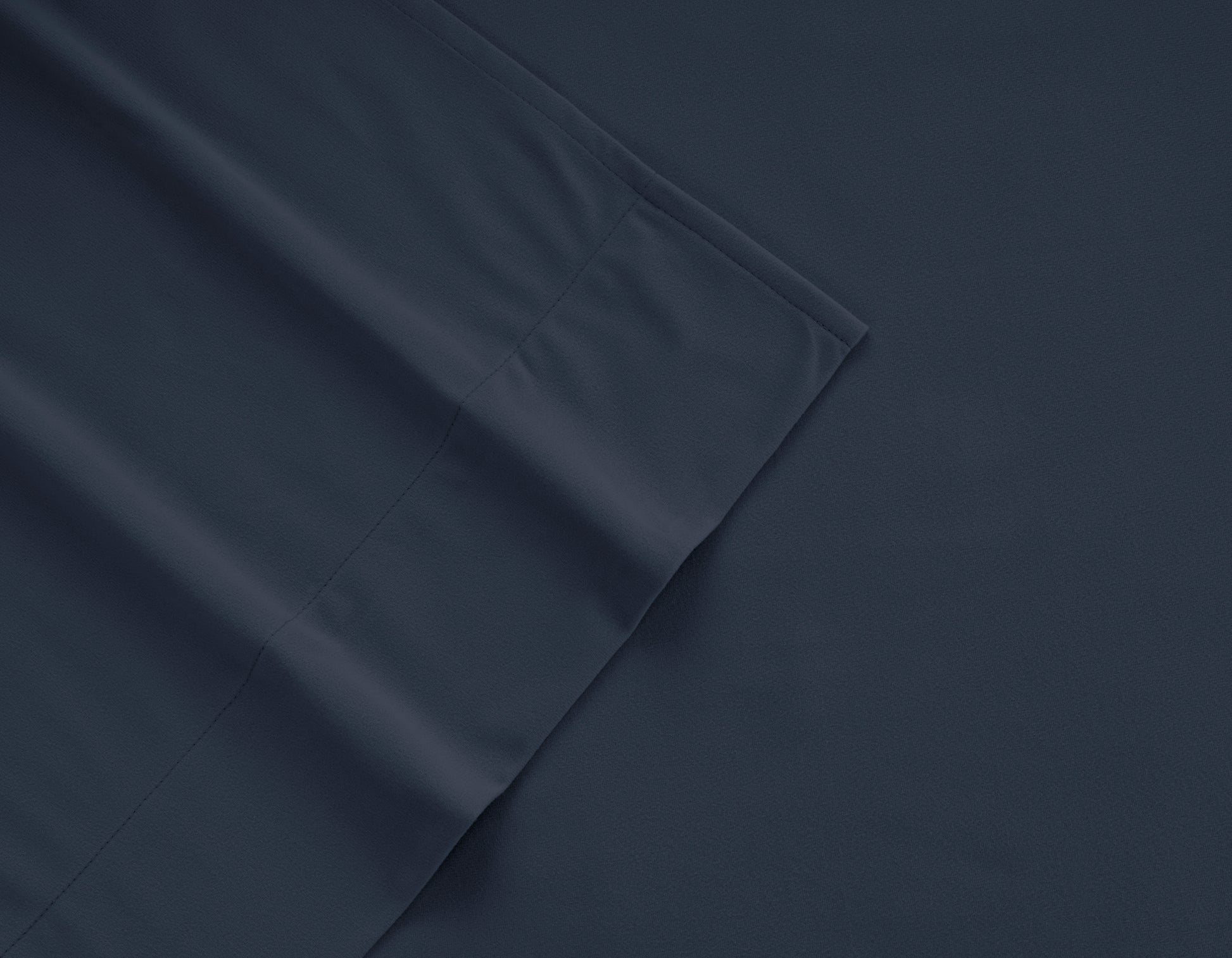 Navy micro flannel sheet fabric close-up with stitched seam detail