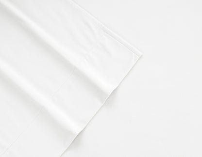 White flannel sheet corner with stitched seam and folded edge detail