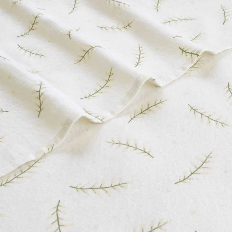 Single sheet set fabric with white background and green branch embroidery, close-up