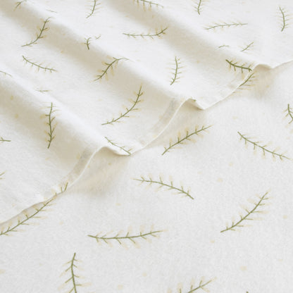 Single sheet set fabric with white background and green branch embroidery, close-up