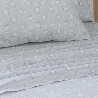 Suns king single sheet set, light blue with star and sun pattern on folded fabric