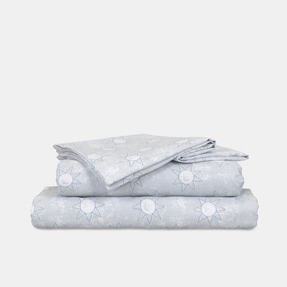 King single sheet set folded stack, light blue with white star and sun motifs