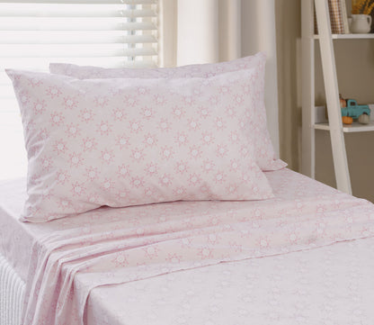 Pink starburst bedding sheet and pillow on a bed