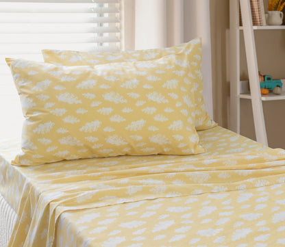 Single cloud sheet set on bed: yellow with white cloud-print pillow and top sheet