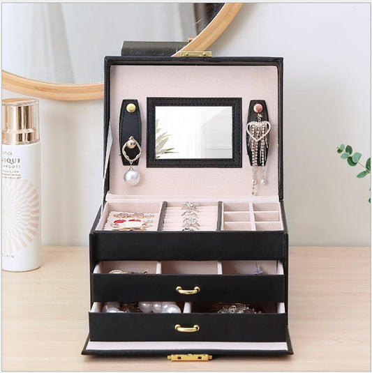 Black jewelry box open with mirror and drawers for rings and earrings, lock case