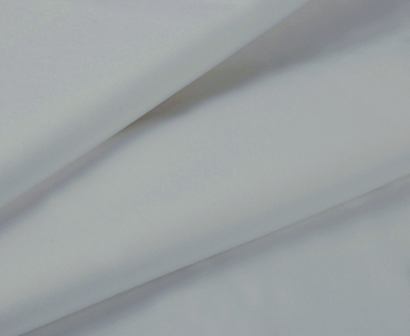 Silver-gray fitted sheet fabric close-up with smooth weave and folded edge
