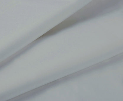 Silver-gray fitted sheet fabric close-up with smooth weave and folded edge