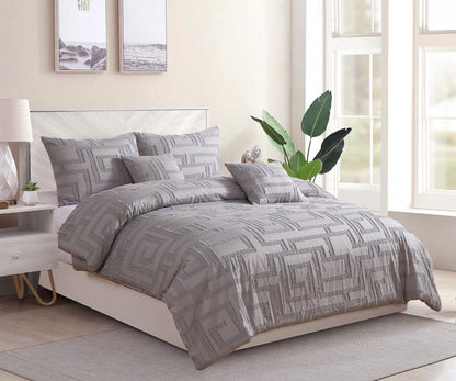 Queen-size grey jacquard quilt set with geometric pattern and matching pillow shams