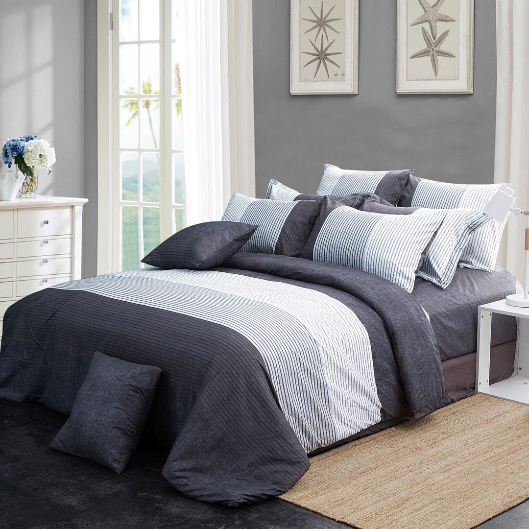 King-size duvet quilt cover set with navy and light blue stripe panels, multiple throw pillows