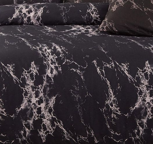 Black marble duvet cover fabric with white marbling pattern, close-up texture