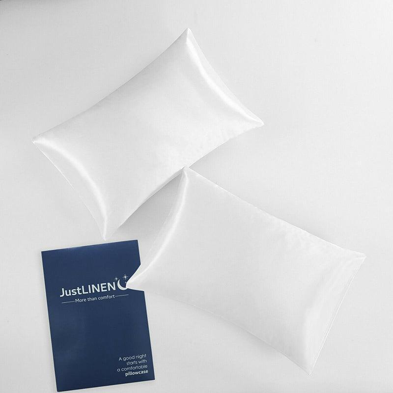 White satin pillowcases, two folded covers with a product card