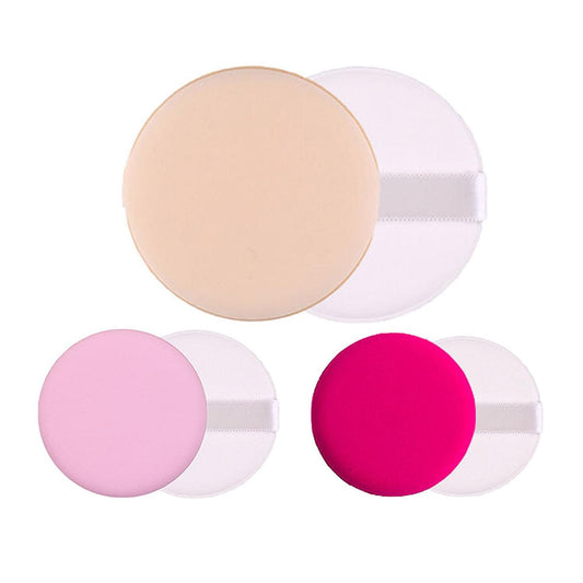 Round powder puff sponges in beige, pink, and bright fuchsia with white backs