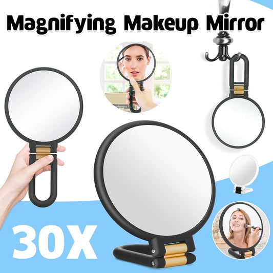 30X handheld magnifying mirror with oval glass, black handle, and foldable stand base