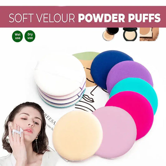 Set of round powder puff sponges in assorted colors, stacked in foreground