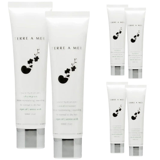 Hair care travel size set showing four white tubes with dark floral logo