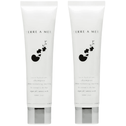 Travel-size shampoo tubes set of 2, white with black floral label and bottom graphic
