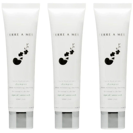 Front-view travel-size shampoo tube, white with Terra A Mer logo and plant icon