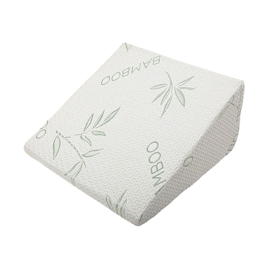 White bed wedge pillow with green bamboo leaf pattern on knit cover