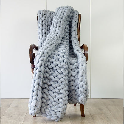 Chunky knit blanket in light grey, thick looped weave with layered drape