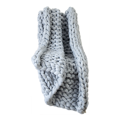 Chunky knit acrylic blanket in light grey, thick braided loops and folded edge