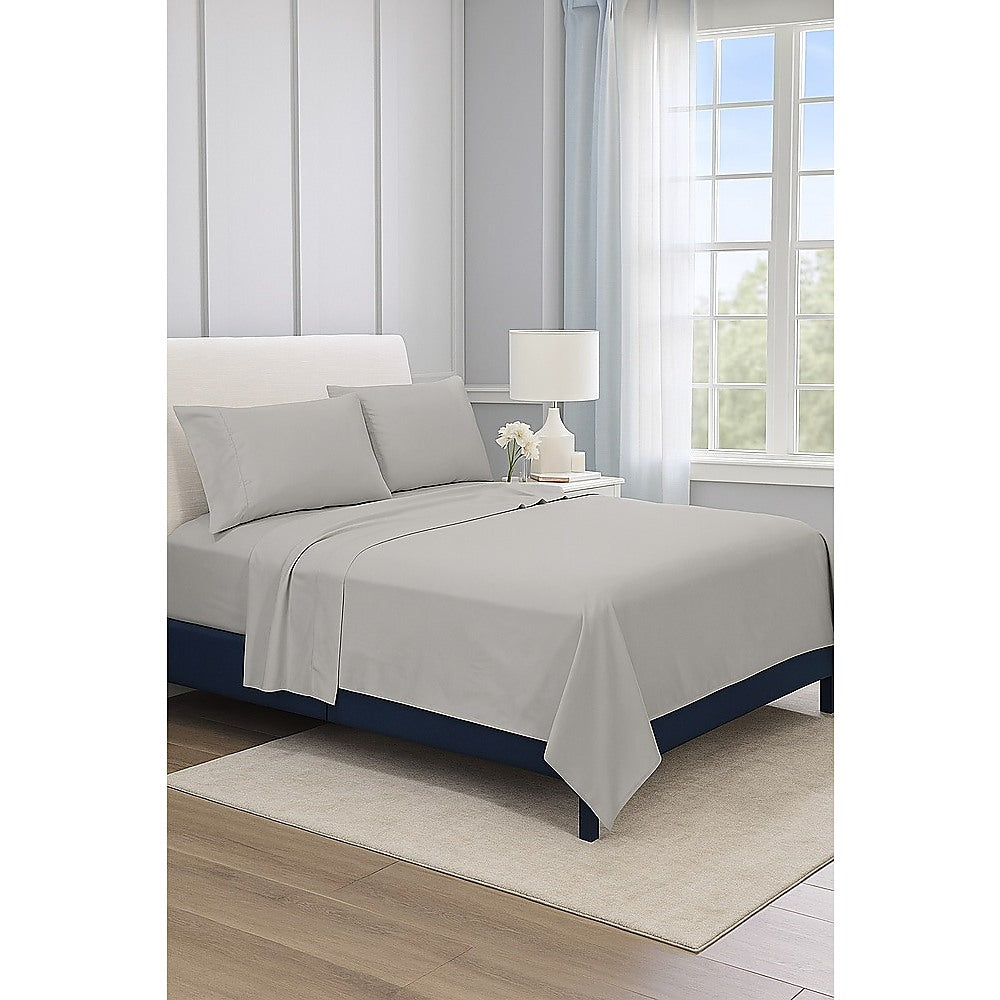 Grey double bed sheet set on bed, with pillowcases and flat sheet