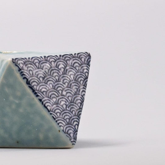 Turquoise triangular vase with wave pattern rim, glazed ceramic.