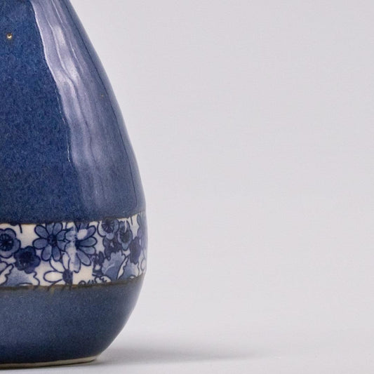 Indigo ceramic vase with blue floral band near the bottom
