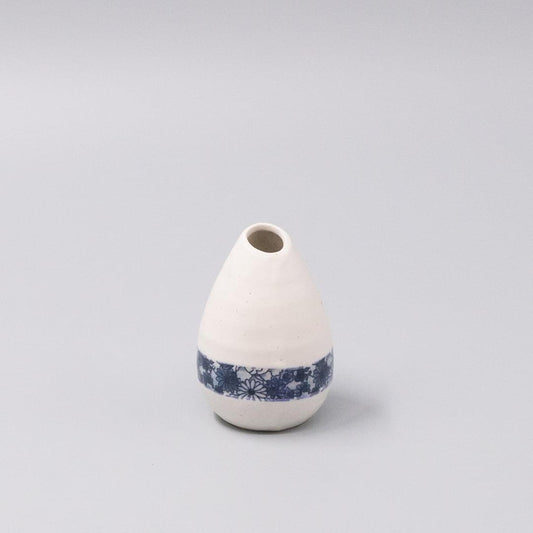 White ceramic vase with blue floral band near base and small round opening