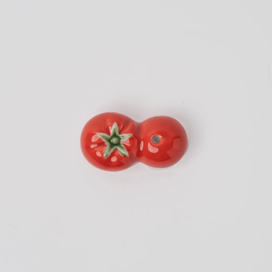 Red tomato incense holder with green detail and small holes
