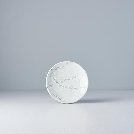 Ceramic plate with white glaze and blue floral vine design, round front view