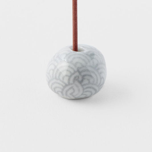 Grey ceramic incense stand with wave pattern, center hole and incense stick