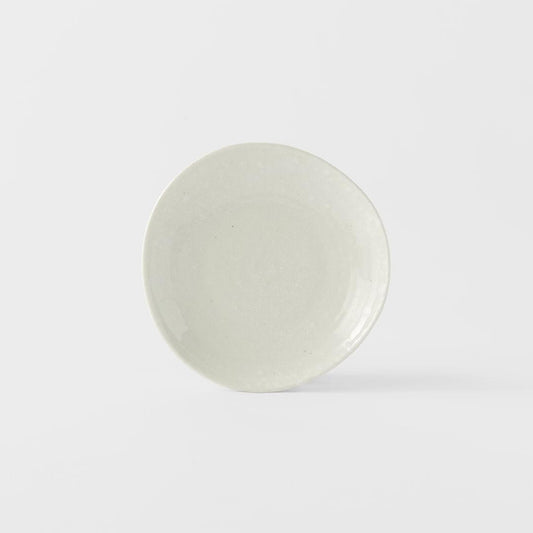 Ceramic saucer with soft white glazed finish, round shallow dish front view