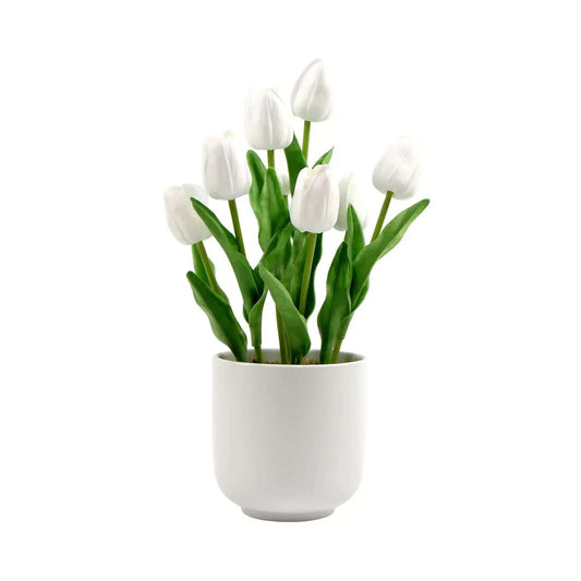 Artificial white tulip arrangement in white ceramic bowl with green stems and leaves