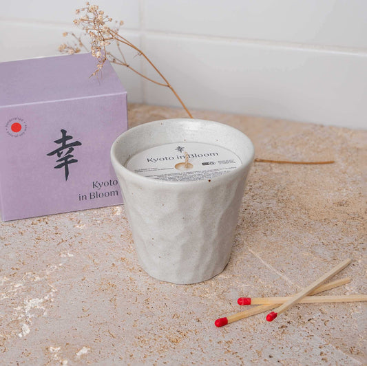 White ceramic candle cup with printed lid label and centered wick opening