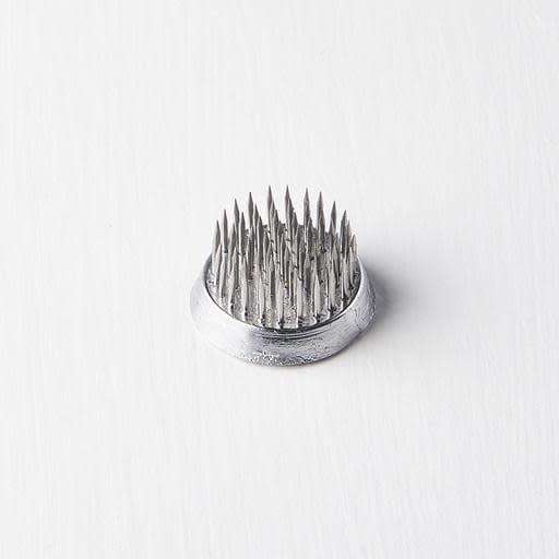 Ikebana pin base with round silver metal base and sharp spike pins