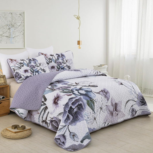 Floral quilt bedspread with matching pillow shams in lavender, blue, and gray botanical print