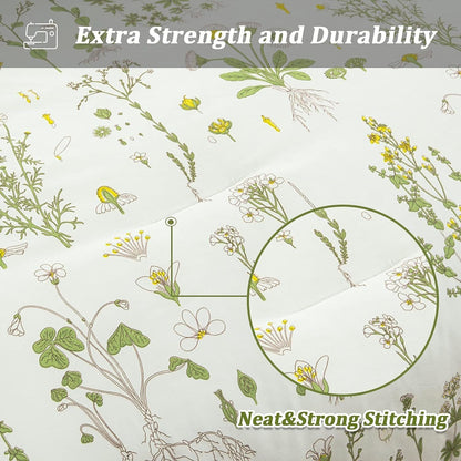 Close-up of white comforter fabric with thin green stems, leaves, and small stitched pattern