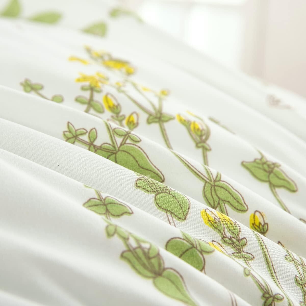 White bedding fabric with green leaf and yellow flower line pattern