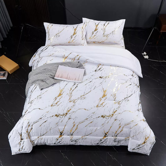 3-piece bedding set on bed: white comforter with gold abstract pattern and two matching pillows