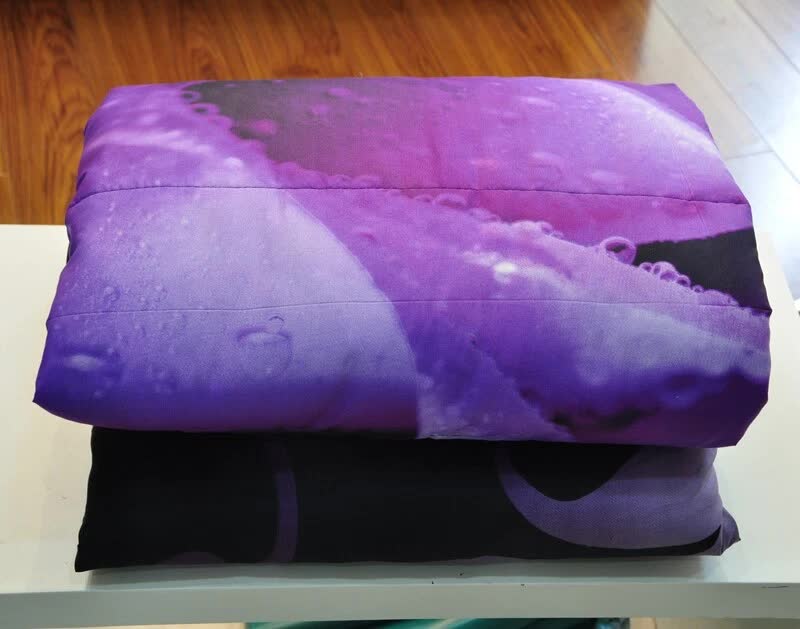Comforter set folded stack: black base with purple rose cloud-like pattern