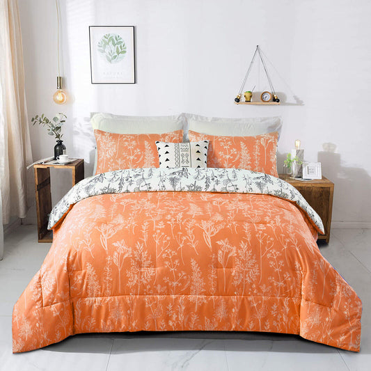 Orange comforter set with white botanical pattern and matching pillow covers