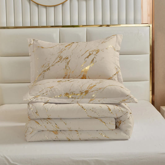 White comforter with gold marble brush pattern and two matching square pillow shams